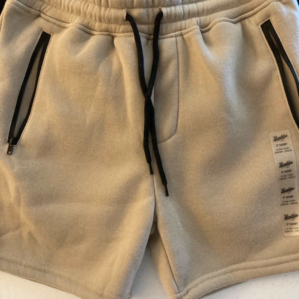 Two boys shorts in black in light brown.